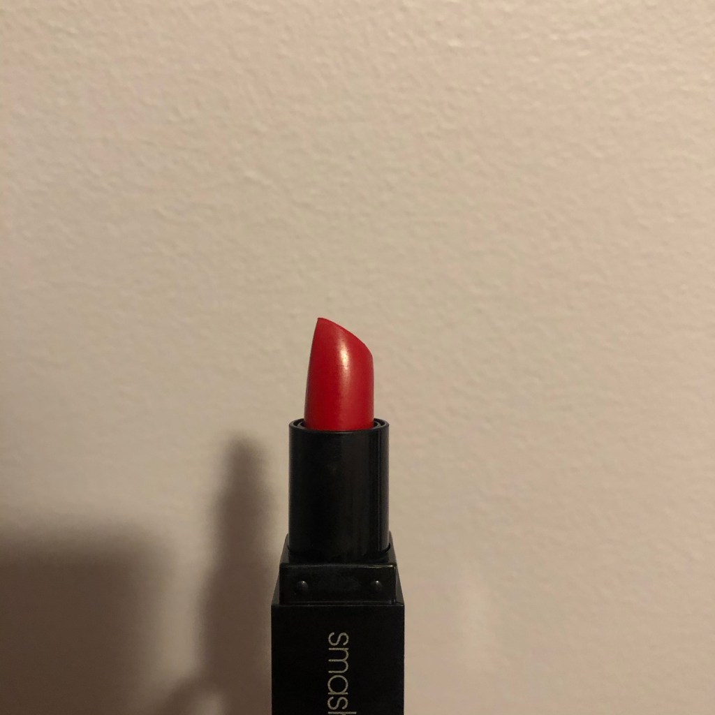 A photo of Smashbox Be Legendary Lipstick in shade Bing Matte with the package opened to reveal the bright blue red lipstick bullet. 