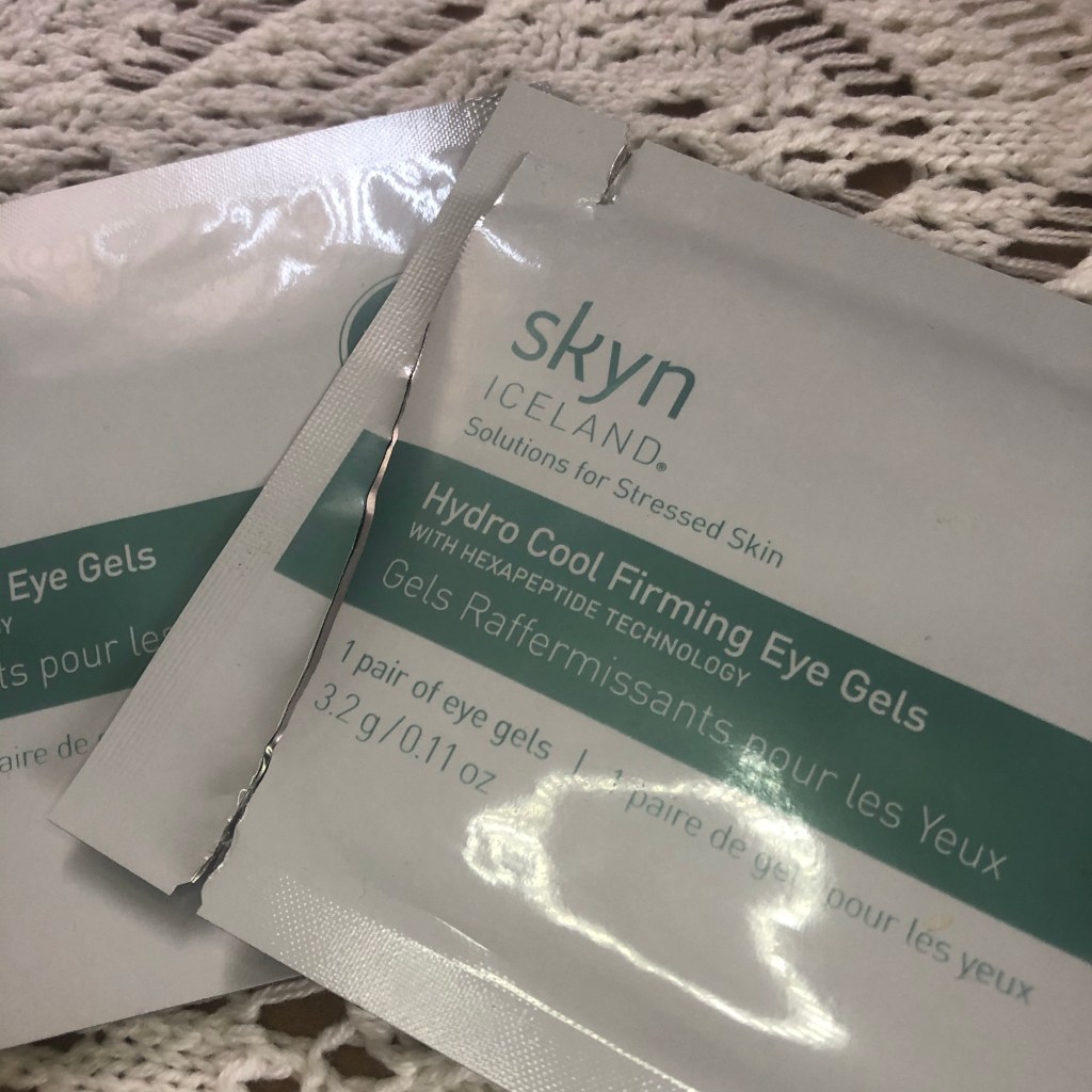 A picture of two opened packs of Skyn Iceland eye patches resting on white crochet background.